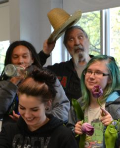 Dino posing with a hat and his classmates
