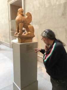 Dino looking at a statue at the Met