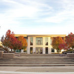 Fall trees and buildings with blue sky