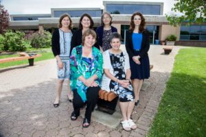 The Nursing Programs faculty and staff smiling outdoors on a spring day.