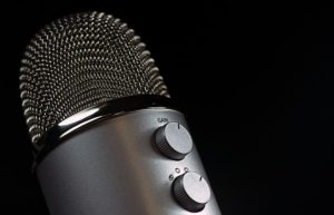black background with a foreground of a microphone