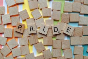 scrabble tiles spelling out the word PRIDE