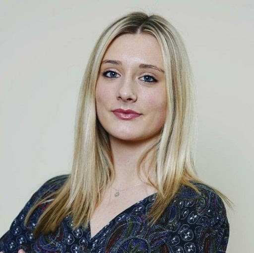 A fair skinned woman with light colored hair, profile shot. 