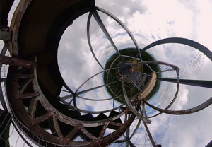 photograph of distorted image with sky and metal