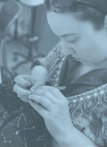 Female student hand sewing a garment