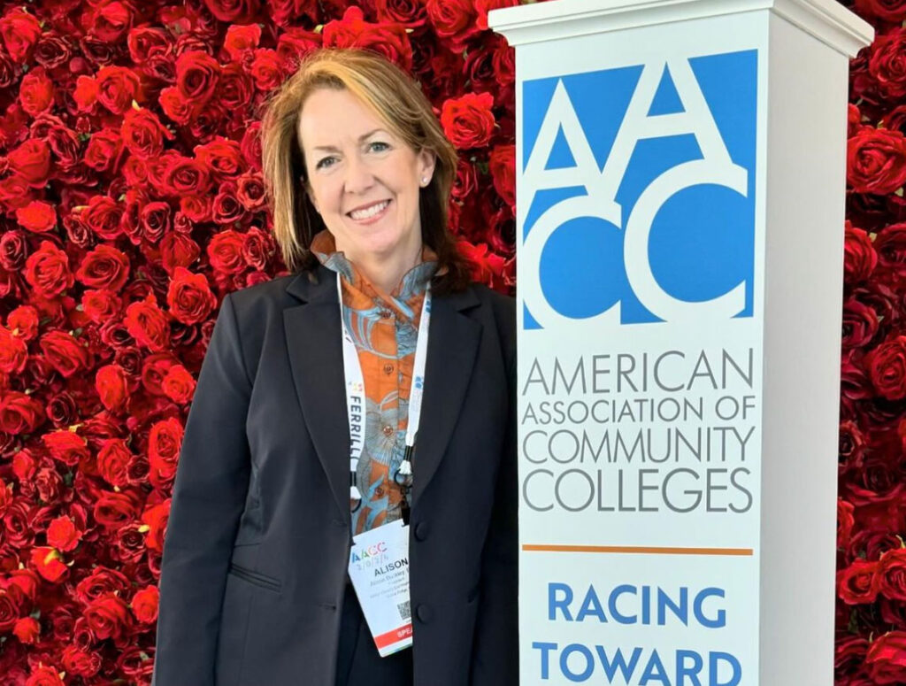 Dr Alison Buckely with AACC sign