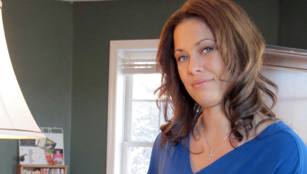 Alethea Shuman stands next to lamp