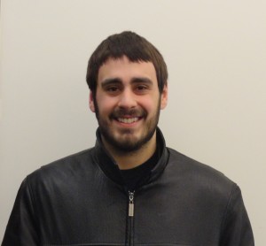 Jacob Berryann stands in front of white wall