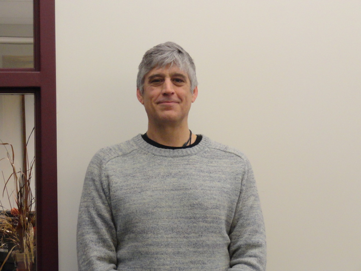 Michael Mulvey stands in front of white wall