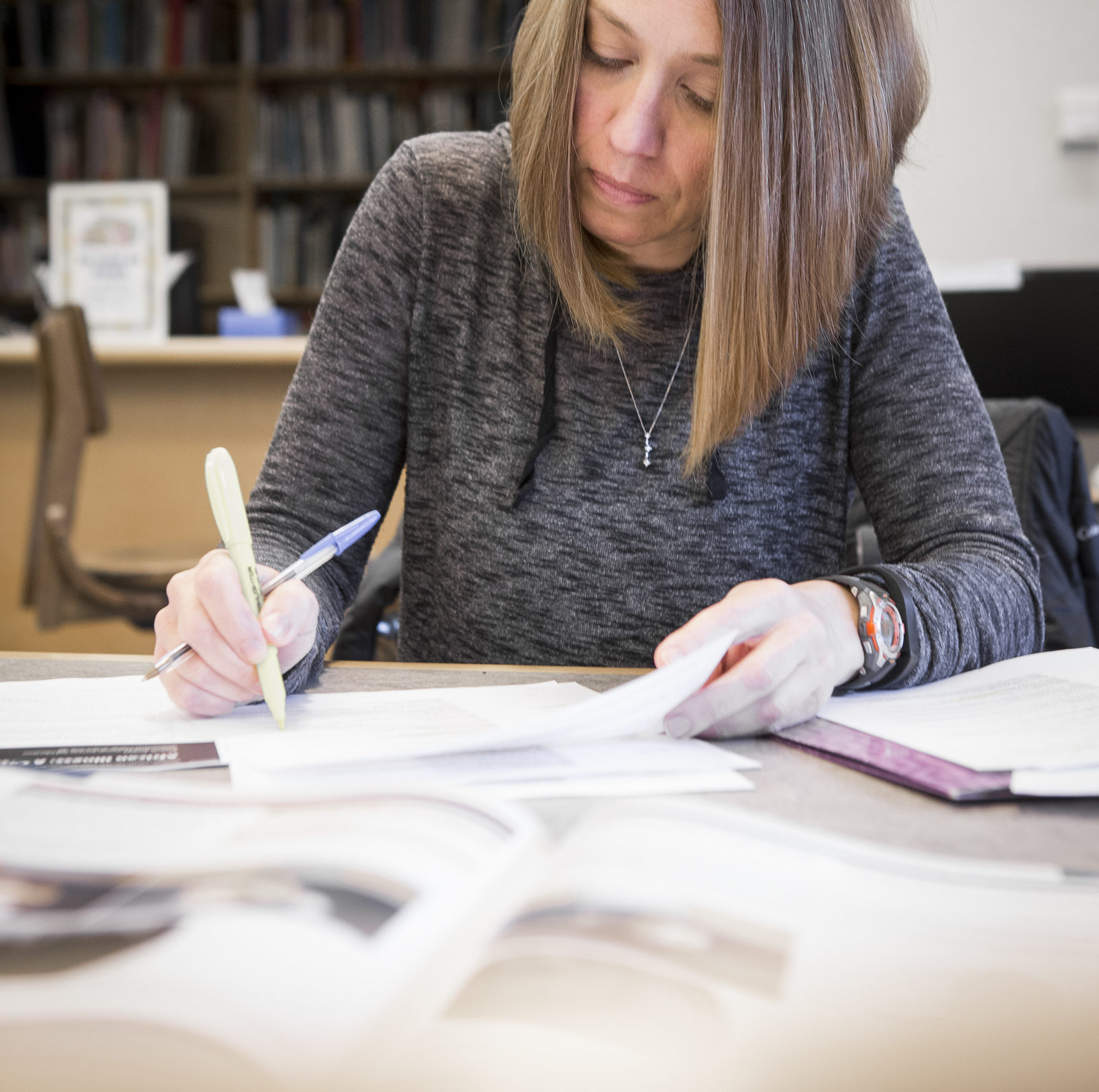 Focused woman doing homework in the library