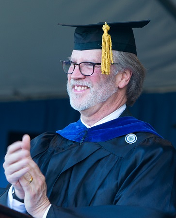 Vice-President and Dean of Academic Affairs Kevin Stoner clapping at graduation ceremony