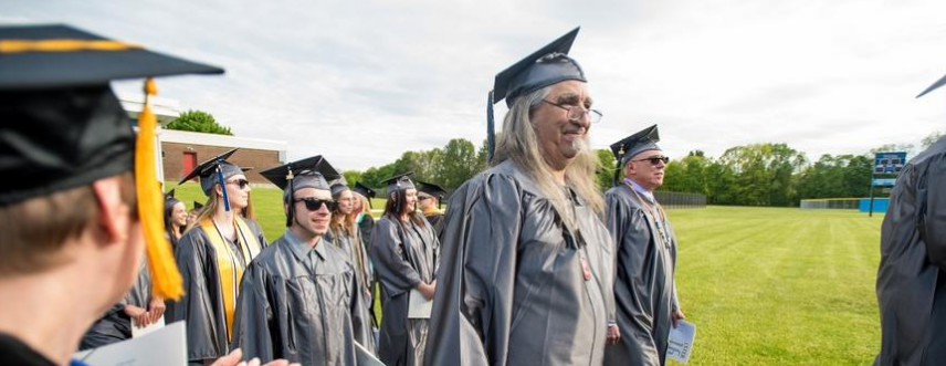 Dino Rende walking at graduation