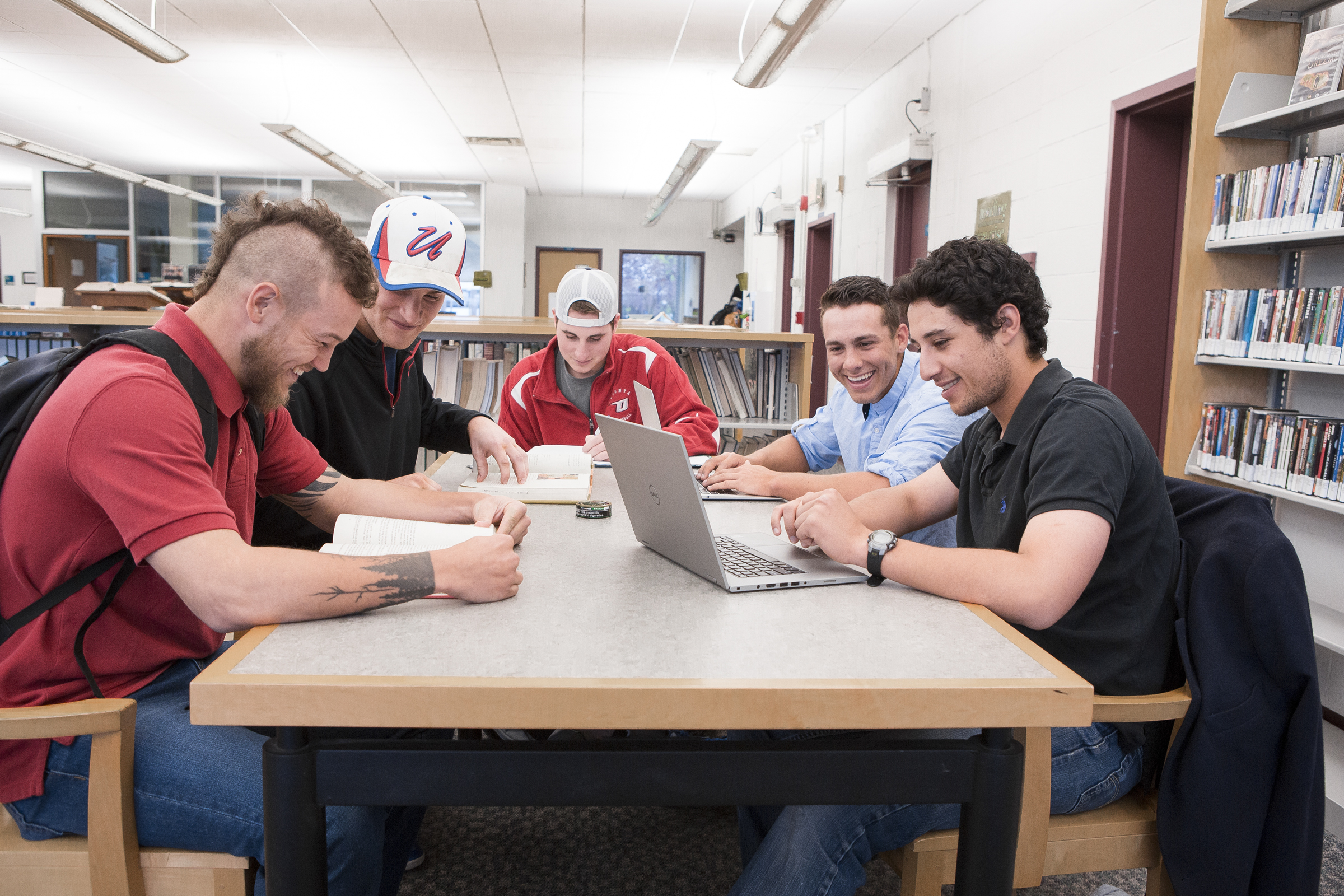 Group of students doing homework together in the library