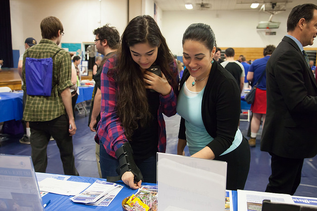 Prospective students looking at materials during Open House