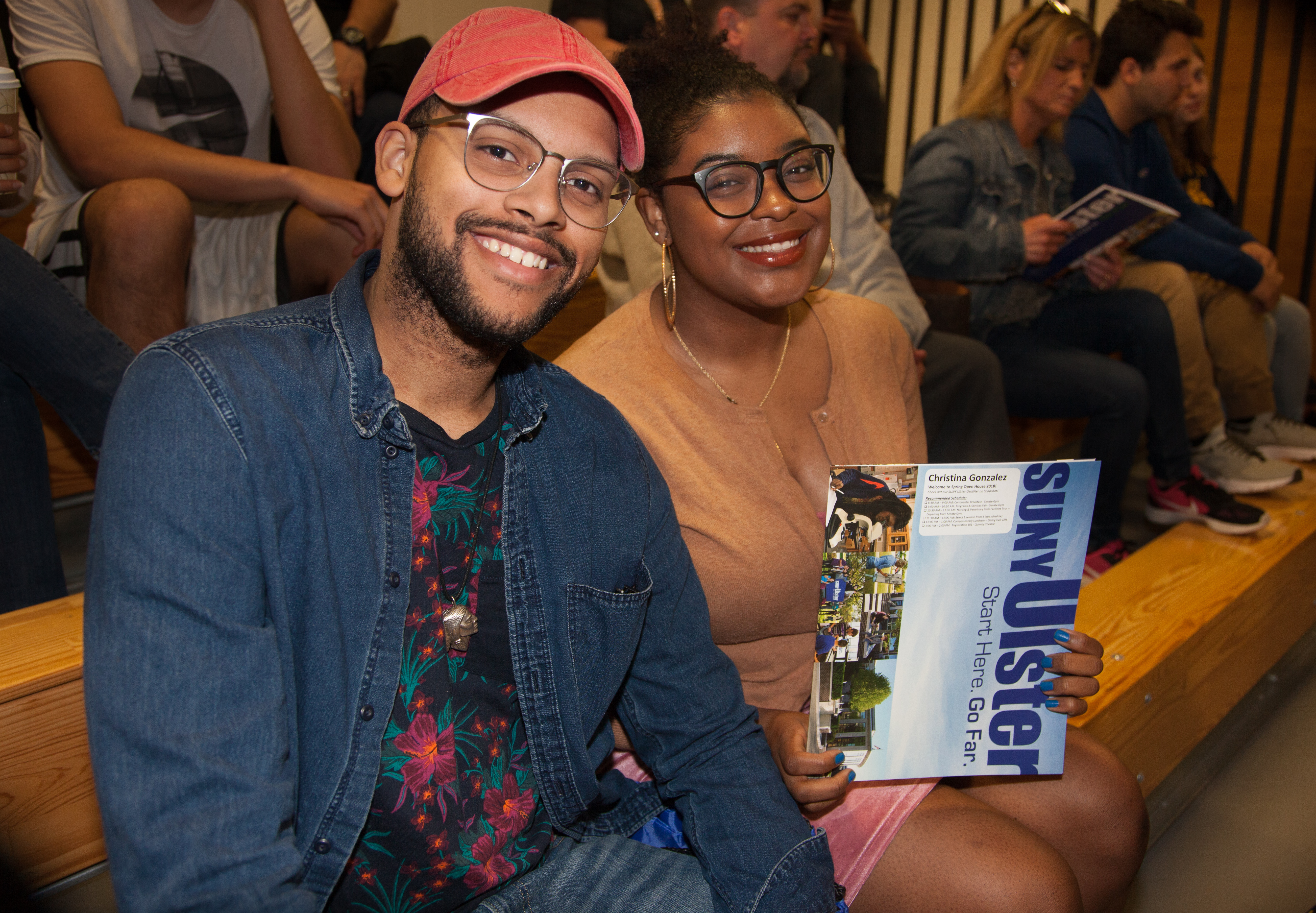 two smiling students with SUNY Ulster folder