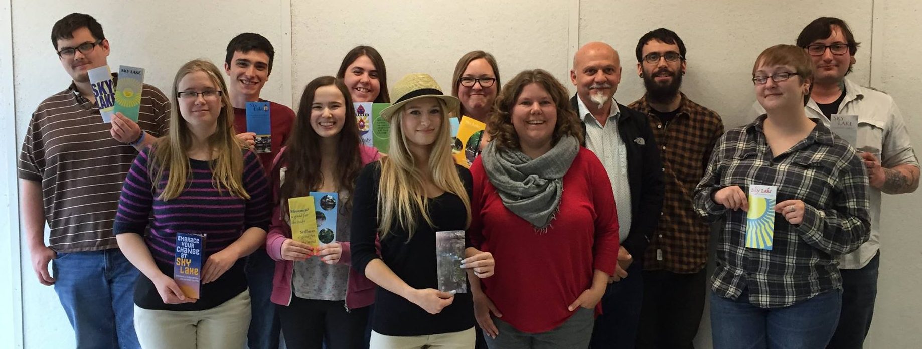 Graphic Design students holding the bee brochures they designed