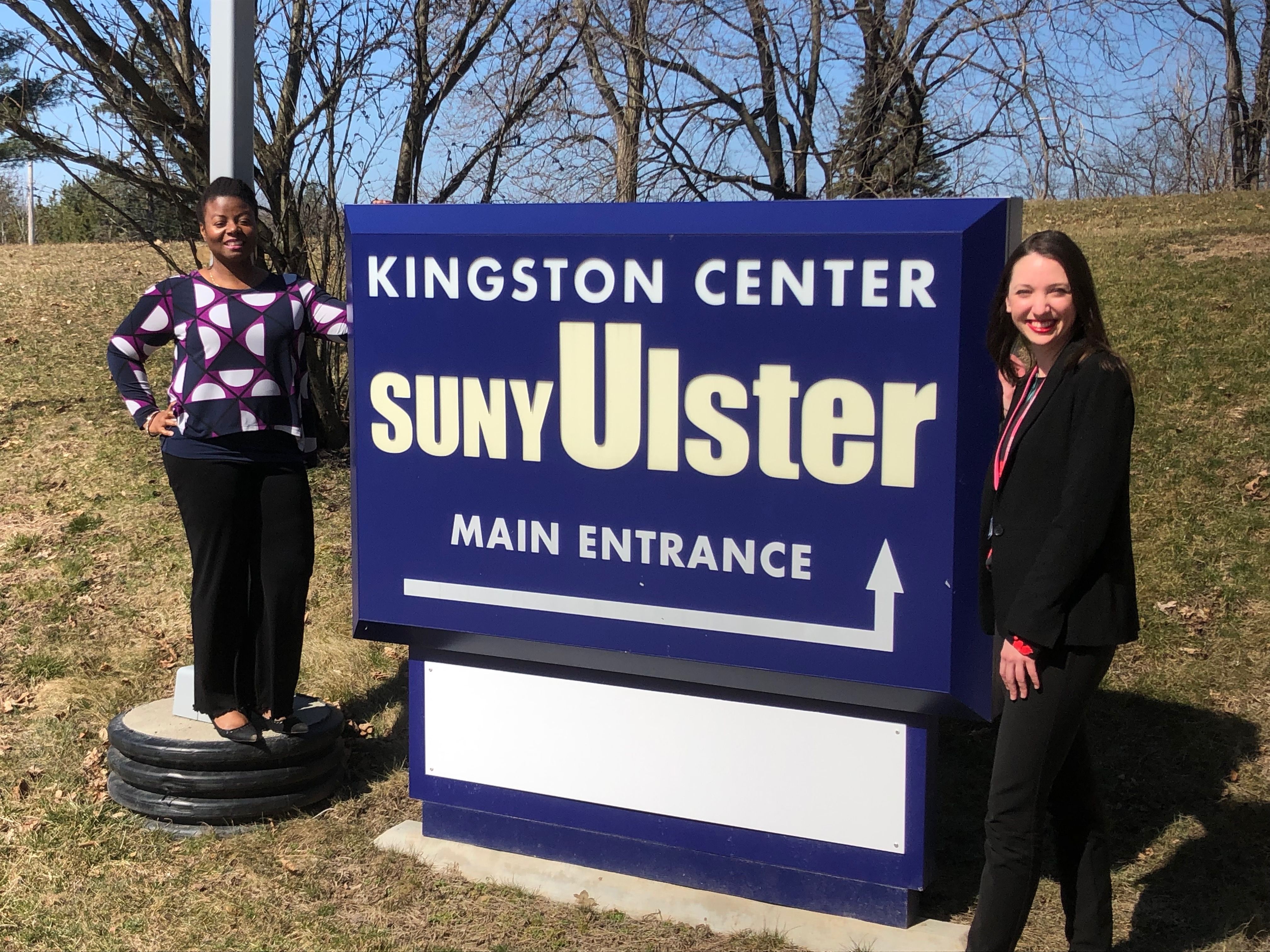 Celeste Hackenberg and Charnikia Pinesett with KCSU sign