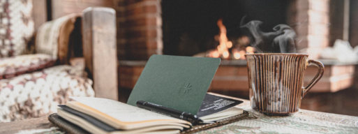 Open book in front of lit fireplace