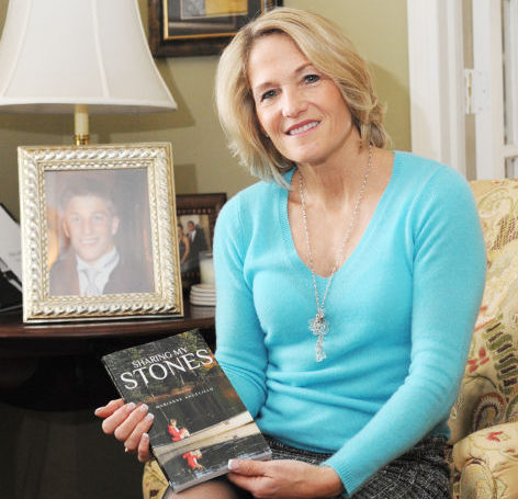 Sharing My Stones author holding her book