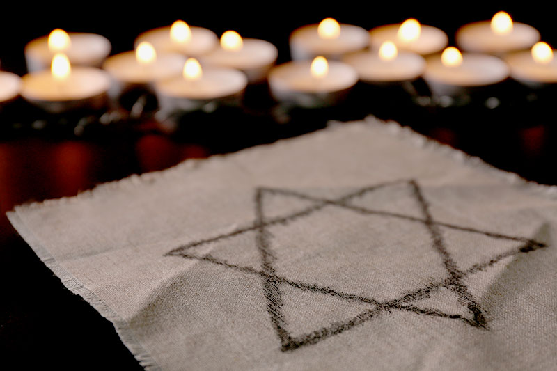 Star of David symbol next to lit candles