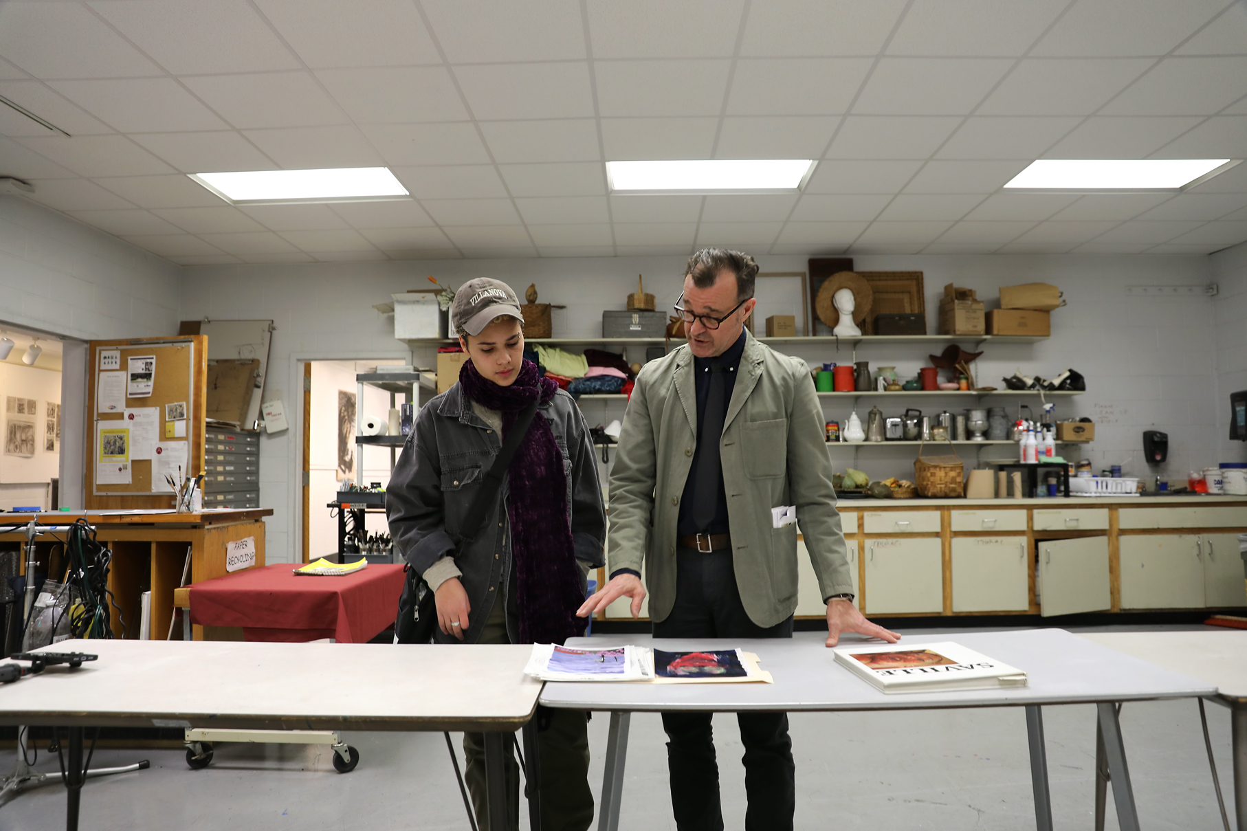 Professor with student in art classroom