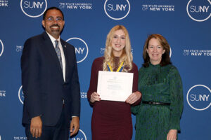 Arianna Moore stands with President and Chancellor