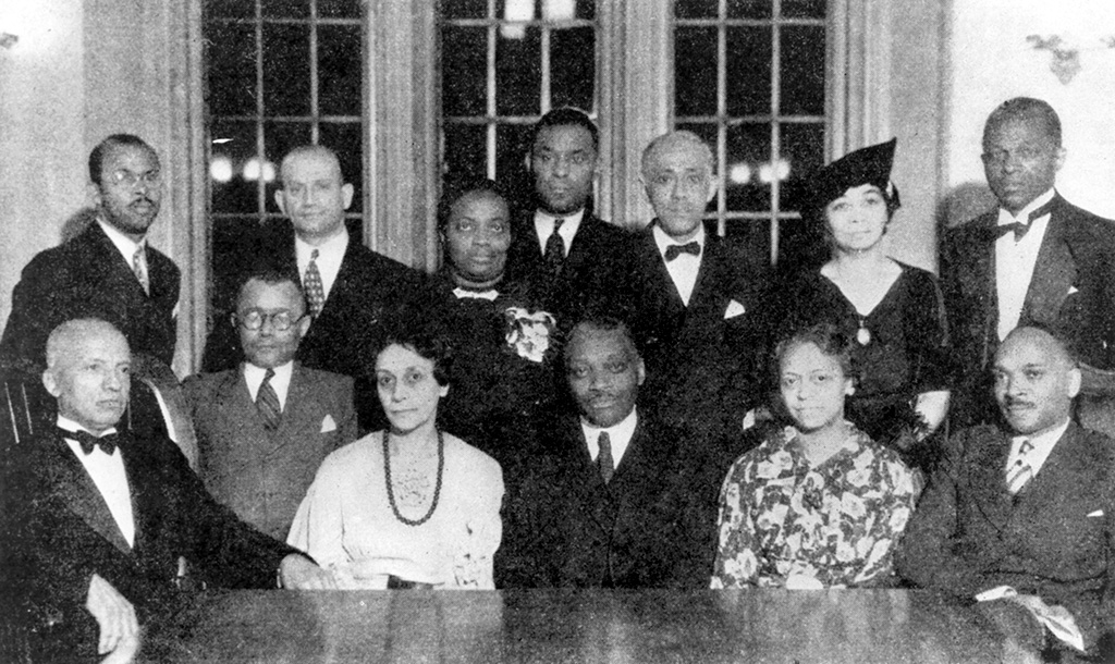 Members of the Association for the Study of Negro Life and History sit at a table posing for a group photo