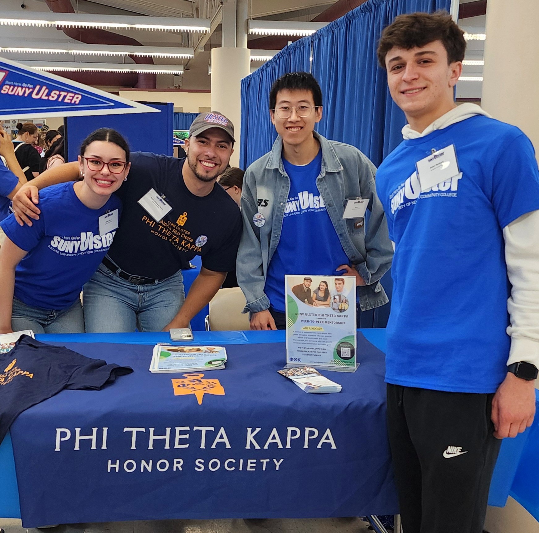 Students around a Phi Tehta Kappa tabe