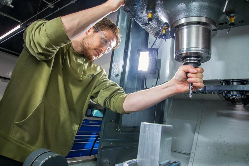 person using manufacturing equipment